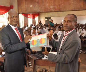 l-r: Executive Director, Lagos and West Bank, Marketing, United Bank for Africa, Liadi Ayoku donating books and other gift items  to the Vice Principal, Academic, Olivet Baptist High School, Oyo, Oyo State, Mr. E.A Adedeji,  during the financial literacy training programme for students of the school, an  initiative of Central Bank of Nigeria, in commemoration of World Savings Day on Monday in Oyo, Oyo State