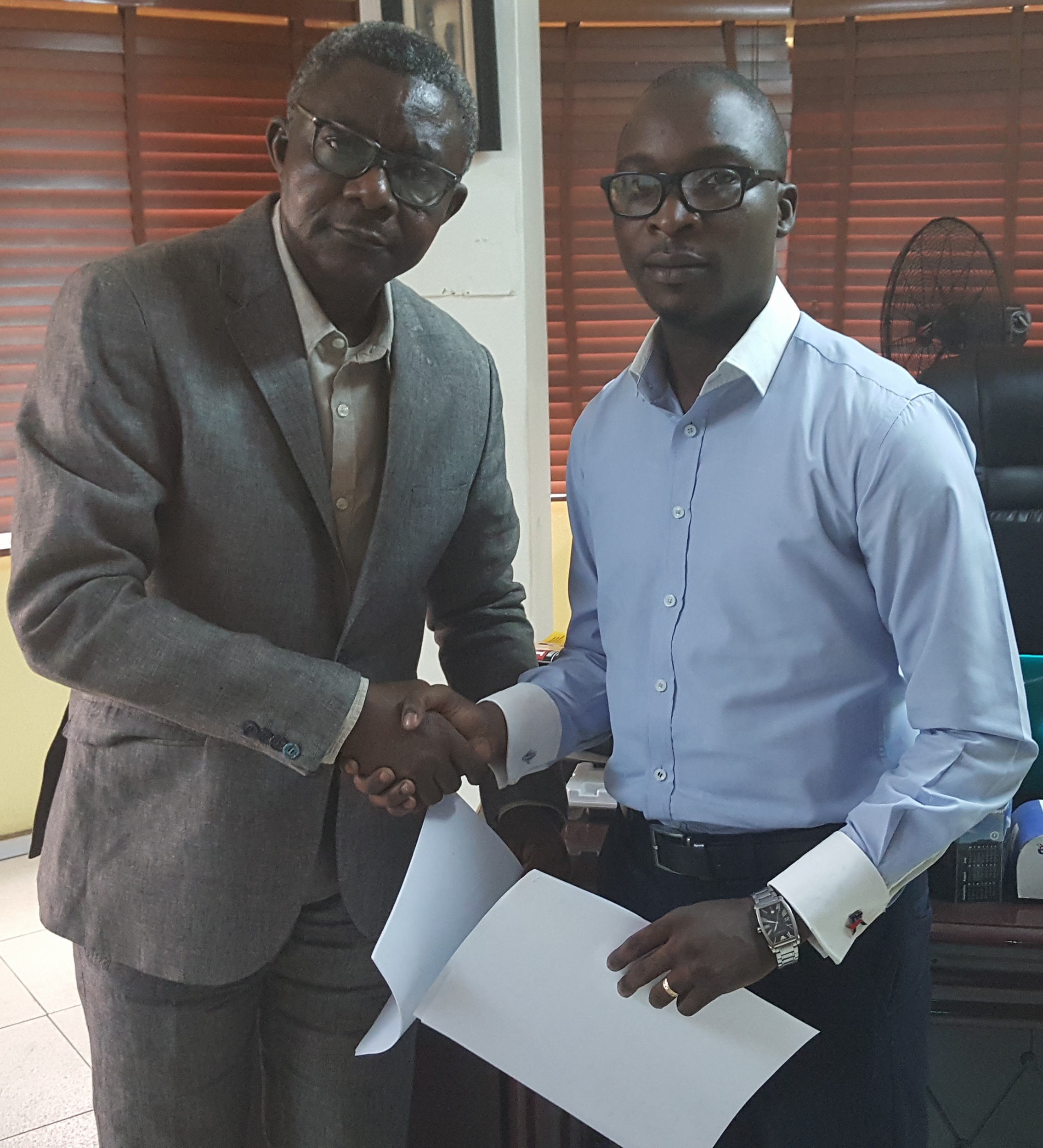 L-R: Tope Ogbeni-Awe, Chief Service Officer of TOPCOMM PR and Gbenga Etti-Williams, Business Development Manager at Webloft Concepts during the signing of the partnership agreement between the two companies.
