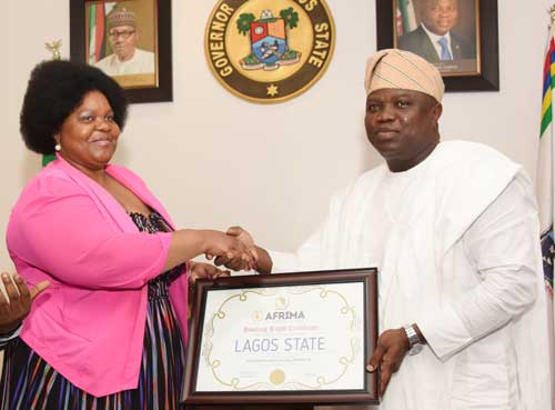 The African Union, Head of Culture, Ms Angela Martin handling the AFRIMA Host City Rights to the Governor of Lagos State, Governor Akinwunmi Ambodi AFRIMA 2017