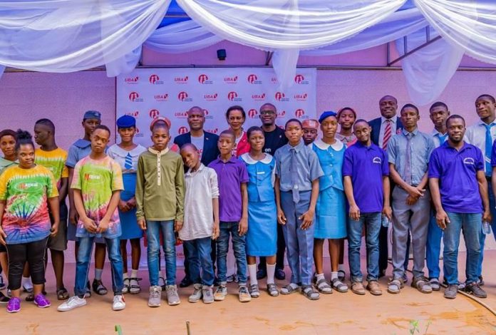 thumbnail-6 Executive Director, United Bank for Africa(UBA) Plc, Mr. Ayoku Liadi; CEO, UBA Foundation, Mrs. Bola Atta; Head, Brand Management, UBA Plc, Mr. Lashe Osoba, flanked by students of various schools during the 2nd edition of UBA Foundation’s ‘Each One, Teach One’ initiative where UBA Staff teach and assist the less privileged, especially students and people living with disabilities across Africa, held in Lagos on Friday.
